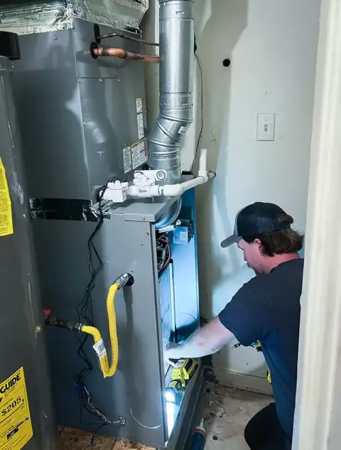 1 Call Heat & Air technician working on an indoor hvac unit